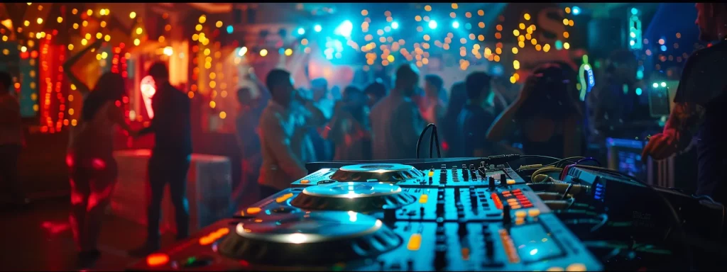 a vibrant and electrifying dj booth, illuminated by dynamic lights, showcases high-quality audio equipment while an enthusiastic crowd dances energetically, creating an atmosphere of celebration and excitement.